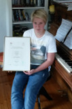 Kind am Klavier mit Zertifikat
